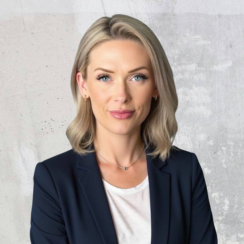 Elliot Morrison, Director of Resource Strategies and Analytics, poses in front of a textured white background for her headshot. Wearing a white blouse and blue blazer, Elliot has a light smile while facing the camera.