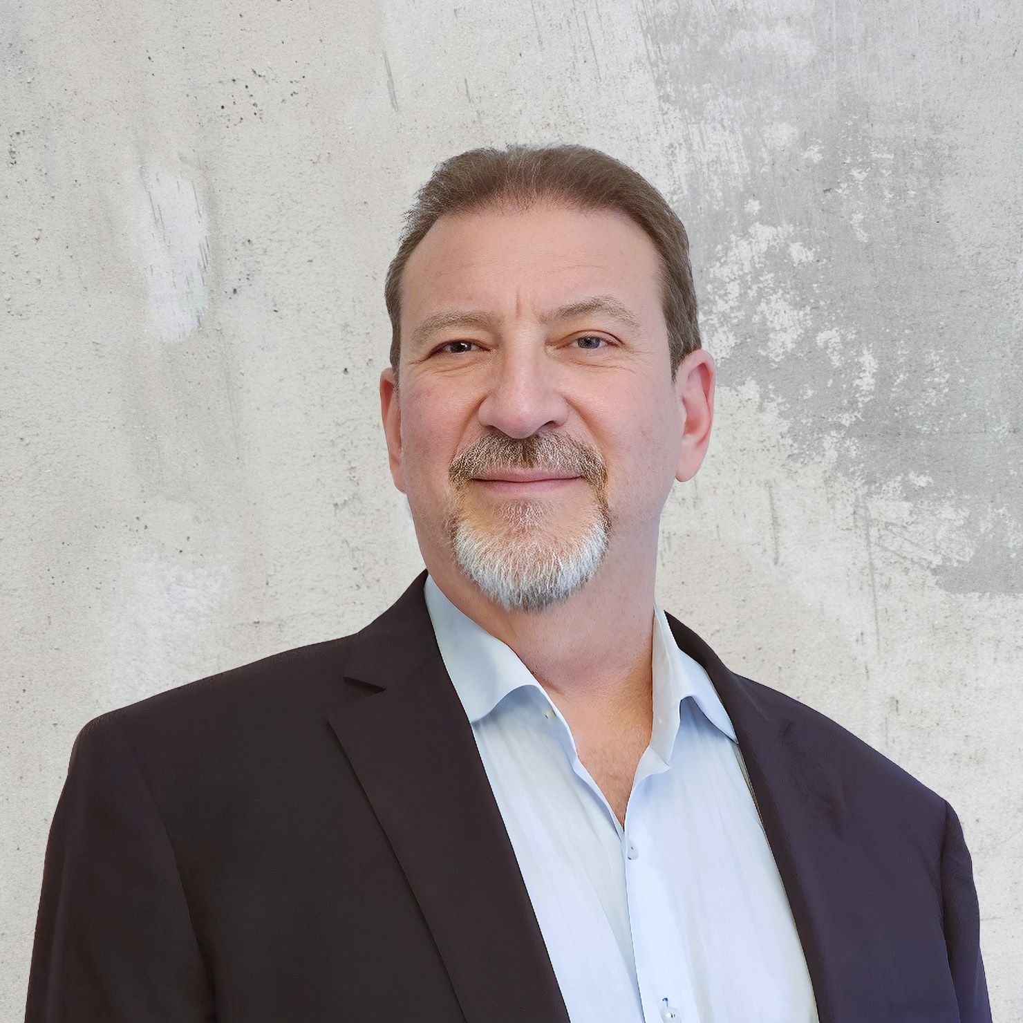 Headshot of Alan Bryum, Vice President of Business Resiliency, wearing a brown blazer and white shirt. He smiles at the camera against a light textured background.