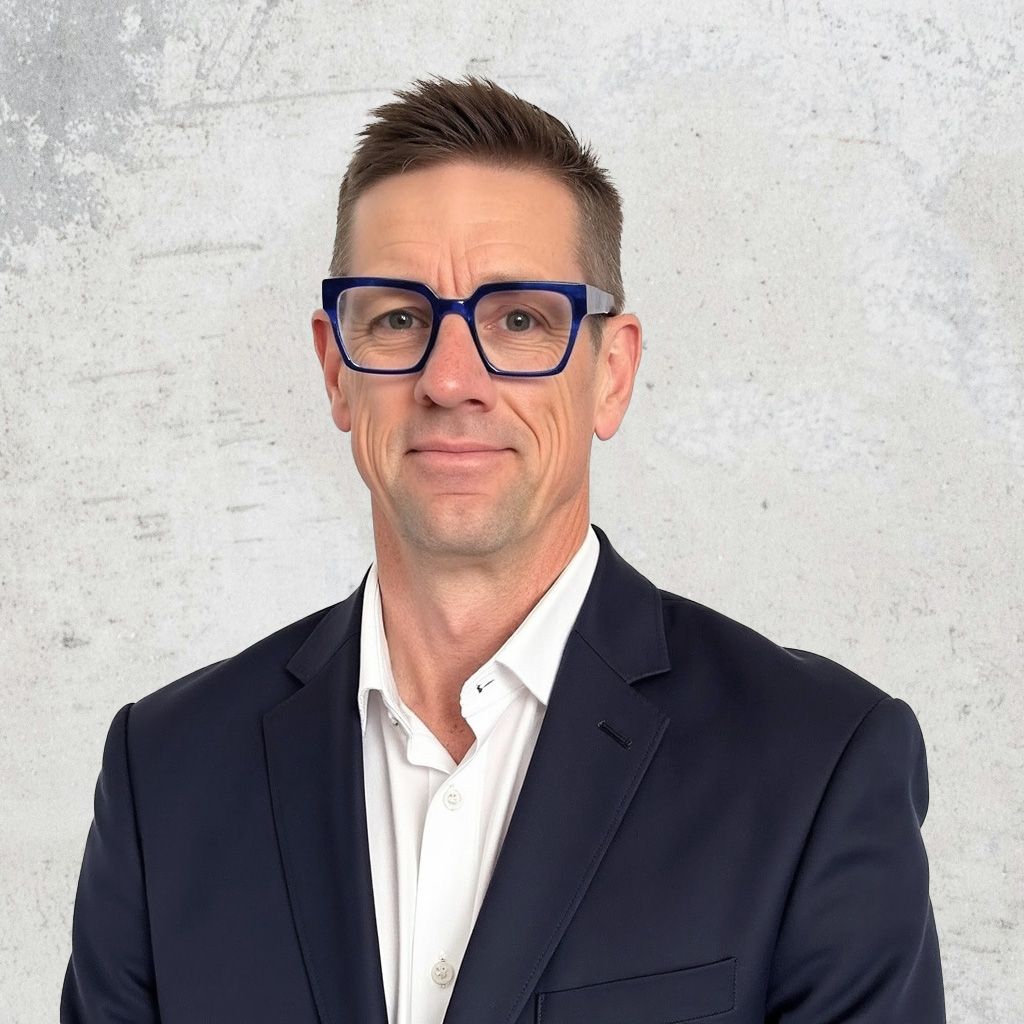 Steve Kay, Director of Consulting Sales and Project Solutions Canada, posing for a headshot in a white shirt and black blazer, captured against a textured white background.